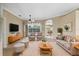 Bright living room featuring comfortable seating, a ceiling fan, and a view of the backyard at 6112 Kinlock Ave, Spring Hill, FL 34608