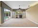 Spacious living room with fireplace and sliding glass doors to the pool area, offering natural light at 6112 Kinlock Ave, Spring Hill, FL 34608
