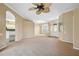 Open living room area with large windows and an archway looking into the kitchen for easy entertaining at 6112 Kinlock Ave, Spring Hill, FL 34608