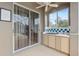 Outdoor patio with a bar, sliding glass doors, and a ceiling fan; perfect for enjoying the outdoors at 6112 Kinlock Ave, Spring Hill, FL 34608