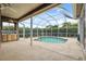 This in-ground pool with screened-in enclosure includes an outdoor kitchenette at 6112 Kinlock Ave, Spring Hill, FL 34608