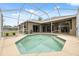 This in-ground pool and screened enclosure are located in the backyard of this home at 6112 Kinlock Ave, Spring Hill, FL 34608