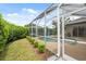 This in-ground pool with screened-in enclosure is accessible from the backyard and patio at 6112 Kinlock Ave, Spring Hill, FL 34608