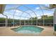 Relax in this crystal-clear pool, surrounded by a screened enclosure and lush greenery at 6112 Kinlock Ave, Spring Hill, FL 34608