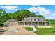 Expansive exterior elevation of home featuring a paver circular driveway, attached garage and screened in front porch at 6331 Griffin Rd, Brooksville, FL 34601