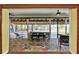 Inviting screened-in porch with brick flooring, ceiling fan, and outdoor dining set overlooking the landscaped backyard at 6331 Griffin Rd, Brooksville, FL 34601