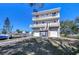 Multi-story canal-front home with balconies, dual garages, and a boat lift for easy water access at 6801 Nowiki Ave, Hudson, FL 34667