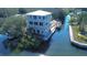 Waterfront home featuring balconies, private dock, boat lift, and canal access at 6801 Nowiki Ave, Hudson, FL 34667