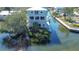 Waterfront home featuring balconies, private dock, boat lift, and canal access at 6801 Nowiki Ave, Hudson, FL 34667