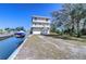 Waterfront home showcasing a private boat lift, three stories, and ample garage space at 6801 Nowiki Ave, Hudson, FL 34667
