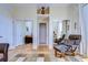 Cozy living room area with hardwood floors, mirrored closet doors, and an inviting armchair at 6801 Nowiki Ave, Hudson, FL 34667