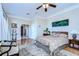 Spacious main bedroom with a king-size bed, sitting area, and en-suite bath at 6801 Nowiki Ave, Hudson, FL 34667