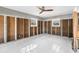 Spacious bedroom featuring sleek tile floors, a modern ceiling fan, and ample natural light from its windows at 8225 Channel Dr, Port Richey, FL 34668