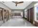 Bright and airy living room featuring sleek tile floors, a modern ceiling fan, and ample natural light at 8225 Channel Dr, Port Richey, FL 34668