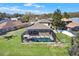 Aerial view of a home with a screened-in pool and spacious backyard, perfect for outdoor entertaining at 10910 May Apple Ct, Land O Lakes, FL 34638