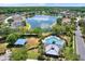 Overhead shot of community pool and clubhouse adjacent to a lake surrounded by beautiful homes at 10910 May Apple Ct, Land O Lakes, FL 34638