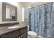 Cozy bathroom featuring vanity with granite countertop, sink, toilet and shower at 10910 May Apple Ct, Land O Lakes, FL 34638