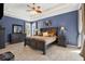 Comfortable primary bedroom with decorative ceiling, large window, and neutral decor at 10910 May Apple Ct, Land O Lakes, FL 34638