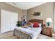 Cozy bedroom with wood-look floors, a wicker headboard, and a convenient bedside table at 10910 May Apple Ct, Land O Lakes, FL 34638