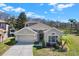 Charming single-Gathering home with attached two-car garage, well-maintained lawn, and lush landscaping at 10910 May Apple Ct, Land O Lakes, FL 34638