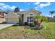 Front view of the beautiful single-Gathering home with attached two-car garage and mature landscaping at 10910 May Apple Ct, Land O Lakes, FL 34638