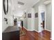 Bright hallway with hardwood floors, neutral walls, and a glimpse into the home's living areas at 10910 May Apple Ct, Land O Lakes, FL 34638
