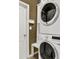 Convenient laundry area with stacked washer and dryer and extra storage space at 10910 May Apple Ct, Land O Lakes, FL 34638