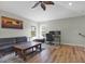 Living room featuring laminate floors, a ceiling fan, and lots of light at 10910 May Apple Ct, Land O Lakes, FL 34638