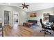 Inviting living room with a vaulted ceiling, wood floors, and a view into a study area at 10910 May Apple Ct, Land O Lakes, FL 34638
