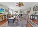 Open living room features ceiling fan, hardwood floors, neutral paint and a dining area at 10910 May Apple Ct, Land O Lakes, FL 34638