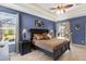 Beautiful main bedroom with tray ceiling, ceiling fan, and access to pool area at 10910 May Apple Ct, Land O Lakes, FL 34638