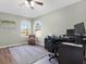 Bright office space featuring two windows, wood-look floors, and a comfortable office setup at 10910 May Apple Ct, Land O Lakes, FL 34638