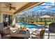 Beautiful screened pool area with a waterfall feature and outdoor seating, perfect for relaxation at 10910 May Apple Ct, Land O Lakes, FL 34638