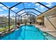 Beautiful pool and screened patio with lake view and rock waterfall feature, ideal for outdoor living at 10910 May Apple Ct, Land O Lakes, FL 34638