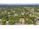 A high aerial view of the neighborhood shows mature trees, ponds, and golf course nearby at 1101 N Betty Ln, Clearwater, FL 33755