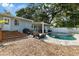 Inviting backyard with pool, patio furniture, and lush greenery for outdoor relaxation and entertainment at 1101 N Betty Ln, Clearwater, FL 33755
