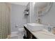 A well-lit bathroom featuring a modern vanity with a white vessel sink and a shower with decorative tile at 1101 N Betty Ln, Clearwater, FL 33755