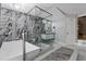 Bathroom with glass enclosed shower, soaking tub, marble tile and sleek fixtures at 1101 N Betty Ln, Clearwater, FL 33755