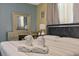 Serene bedroom with a decorative vanity and a mirrored dresser, complemented by modern lighting fixtures at 1101 N Betty Ln, Clearwater, FL 33755