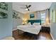 Cozy bedroom with wood floors, ceiling fan, and colorful decor at 1101 N Betty Ln, Clearwater, FL 33755