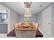 Dining room with elegant chandelier over large wood table with seating for six at 1101 N Betty Ln, Clearwater, FL 33755