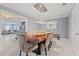 Open concept dining room features an elegant chandelier over a large wood table with seating for six at 1101 N Betty Ln, Clearwater, FL 33755