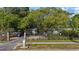 Charming home behind a secure fence, nestled under a large shady tree with a private driveway at 1101 N Betty Ln, Clearwater, FL 33755