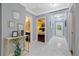 Hallway with marble floors features view to the bathroom and a bedroom at 1101 N Betty Ln, Clearwater, FL 33755