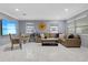 Bright living room features marble floors, neutral paint and a tan leather sectional sofa at 1101 N Betty Ln, Clearwater, FL 33755