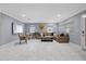 Bright living room features marble floors, neutral paint and a tan leather sectional sofa at 1101 N Betty Ln, Clearwater, FL 33755