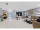 Bright living room features marble floors and neutral paint, with view to front entry and bedroom at 1101 N Betty Ln, Clearwater, FL 33755