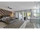 Bedroom with exterior access, sitting area and ensuite bath with glass enclosed shower at 1101 N Betty Ln, Clearwater, FL 33755
