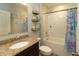 A charming bathroom offers a shower-tub combo with tiled walls and a granite-topped vanity at 11134 Horned Owl Rd, Weeki Wachee, FL 34614