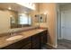 Bathroom with double sinks, granite countertop, and framed mirrors, offering a sleek look at 11134 Horned Owl Rd, Weeki Wachee, FL 34614